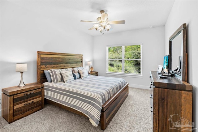 bedroom featuring ceiling fan, light carpet, and baseboards