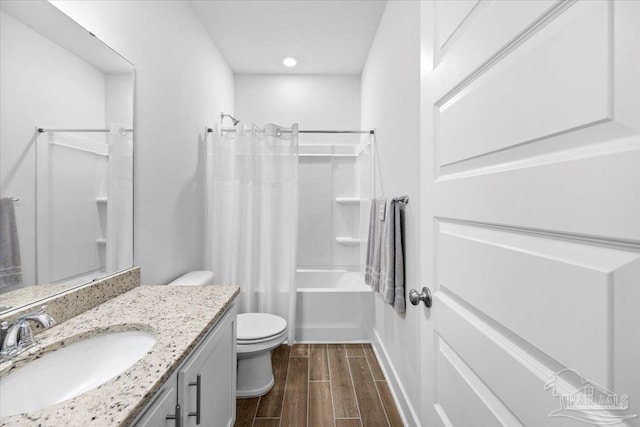 bathroom with shower / bath combo, toilet, vanity, and wood finished floors