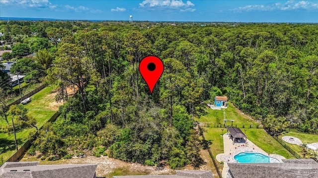 drone / aerial view featuring a forest view