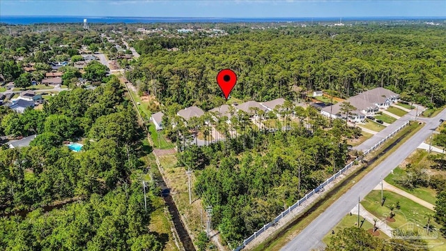 drone / aerial view featuring a residential view and a view of trees
