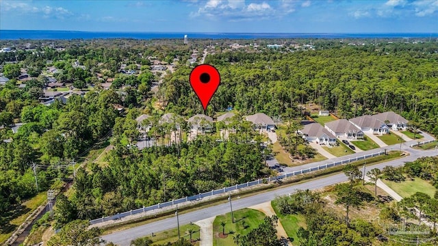 drone / aerial view featuring a view of trees and a residential view