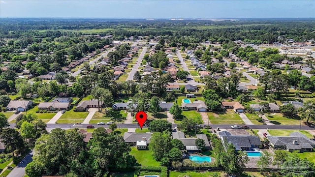 birds eye view of property featuring a residential view and a wooded view