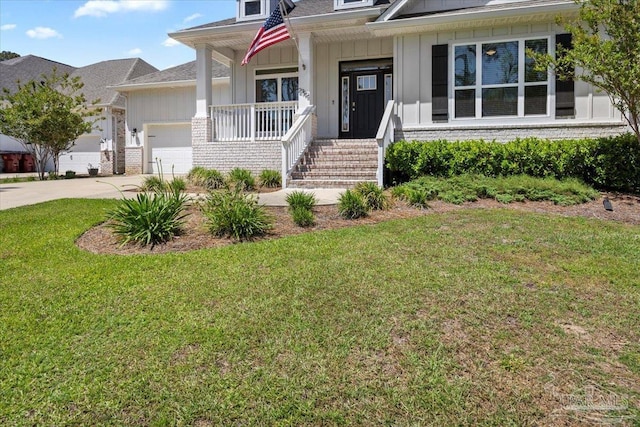 view of front of property featuring board and batten siding, an attached garage, a porch, and a front lawn