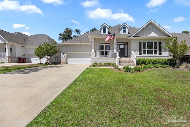 craftsman-style home with a front lawn, concrete driveway, board and batten siding, a porch, and a garage