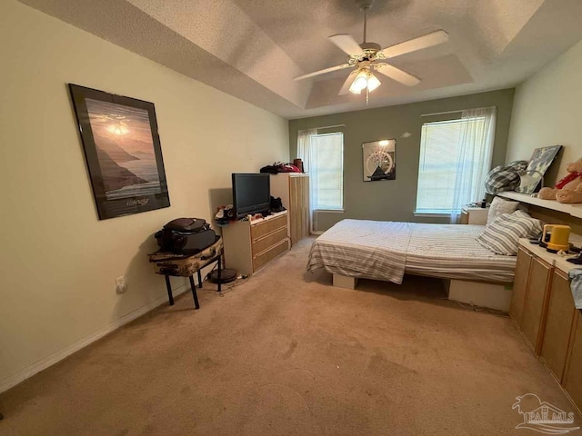 1640 Steven Dr, Gulf Breeze, FL 32563 - bedroom featuring light carpet, a tray ceiling, and ceiling fan