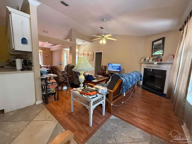 1640 Steven Dr, Gulf Breeze, FL 32563 - living area with a glass covered fireplace, lofted ceiling, ceiling fan, and light wood-style flooring