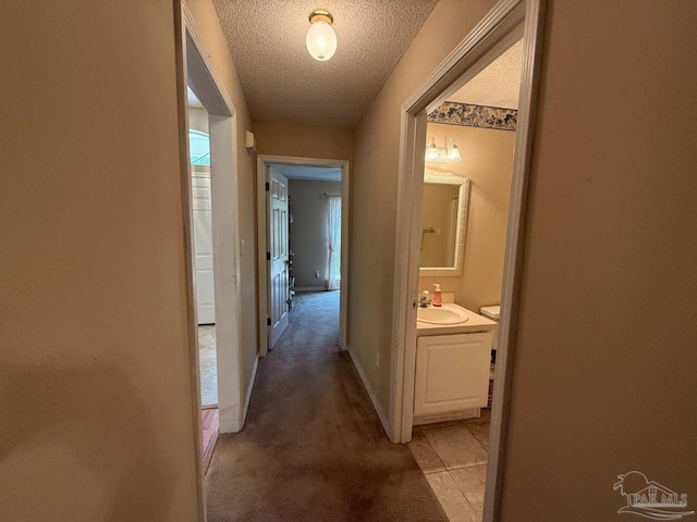 1640 Steven Dr, Gulf Breeze, FL 32563 - hallway with a textured ceiling, light carpet, and light tile patterned floors
