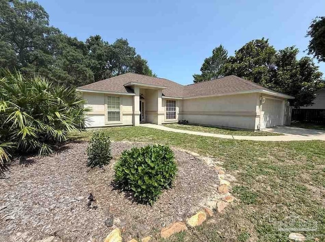 1640 Steven Dr, Gulf Breeze, FL 32563 - single story home with an attached garage, stucco siding, a front yard, and driveway