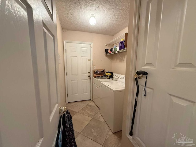 1640 Steven Dr, Gulf Breeze, FL 32563 - laundry area with washing machine and dryer, a textured ceiling, and light tile patterned floors