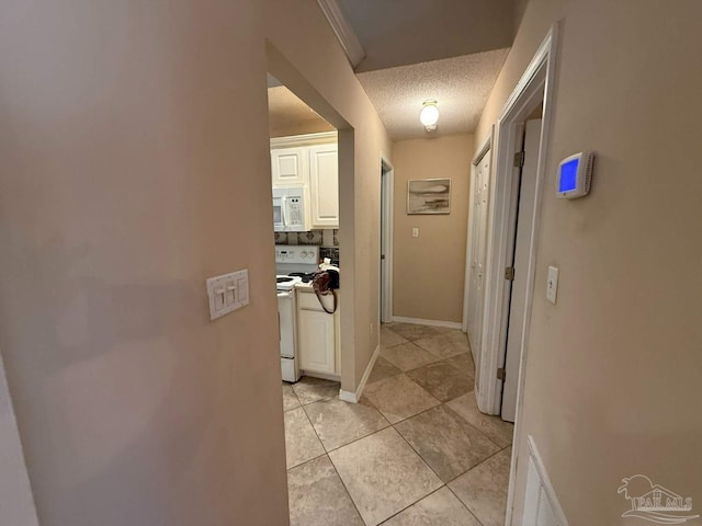 1640 Steven Dr, Gulf Breeze, FL 32563 - corridor featuring light tile patterned floors and a textured ceiling