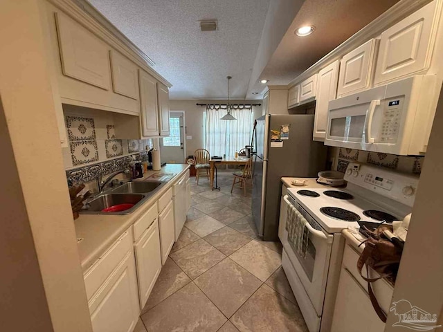 1640 Steven Dr, Gulf Breeze, FL 32563 - kitchen with white appliances, a textured ceiling, light countertops, hanging light fixtures, and recessed lighting
