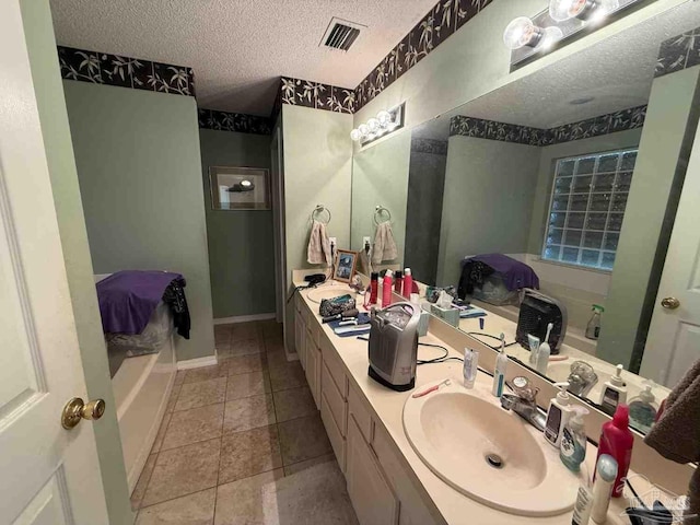 1640 Steven Dr, Gulf Breeze, FL 32563 - bathroom featuring a textured ceiling, double vanity, tile patterned flooring, and a bathtub