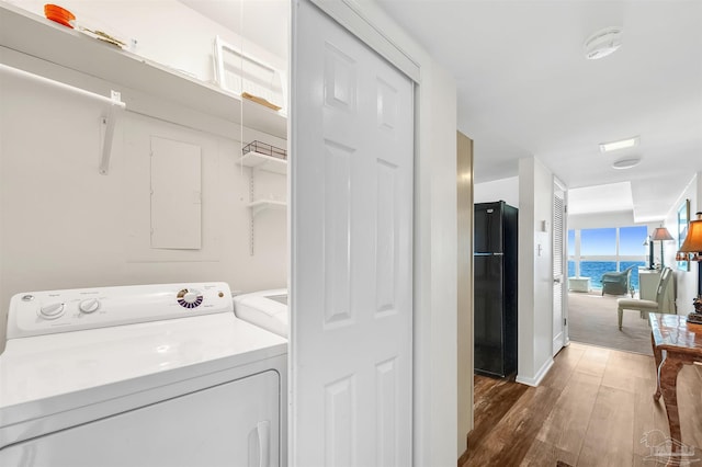 1007 W Beach Blvd Unit 53, Gulf Shores, AL 36542 - laundry area with wood finished floors and washer and dryer