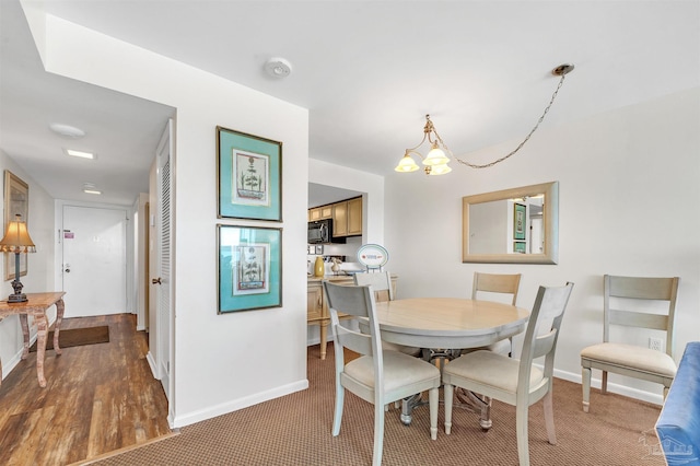 1007 W Beach Blvd Unit 53, Gulf Shores, AL 36542 - dining room with baseboards and a chandelier