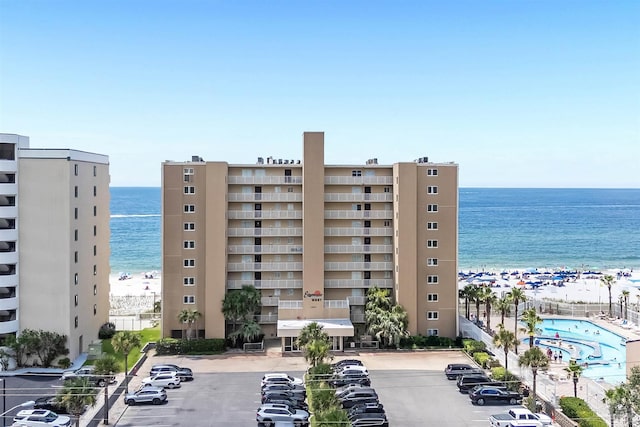 1007 W Beach Blvd Unit 53, Gulf Shores, AL 36542 - view of building exterior featuring uncovered parking and view of water and beach