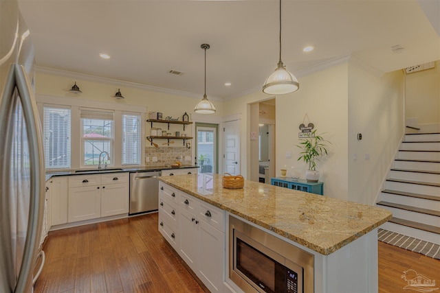 kitchen featuring white cabinets, visible vents, stainless steel appliances, and hardwood / wood-style flooring