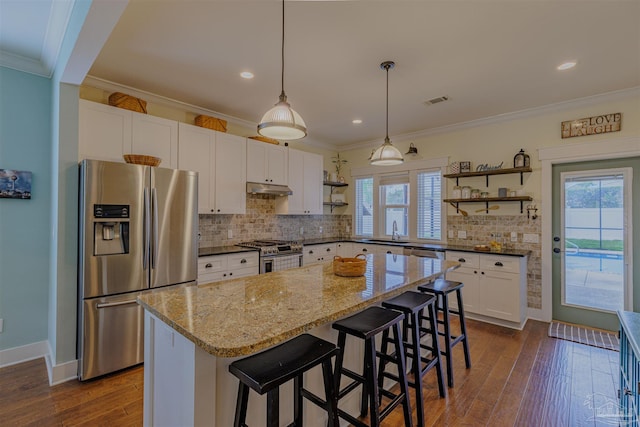 kitchen featuring open shelves, tasteful backsplash, crown molding, and appliances with stainless steel finishes