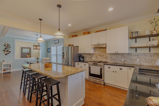 kitchen featuring white cabinets, appliances with stainless steel finishes, under cabinet range hood, a sink, and open shelves
