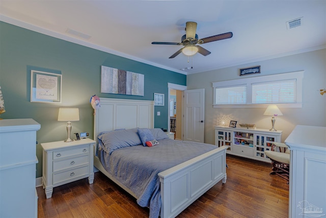 bedroom featuring a ceiling fan, dark wood-type flooring, crown molding, and visible vents