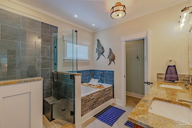 full bathroom with a sink, a garden tub, tile patterned floors, and a stall shower