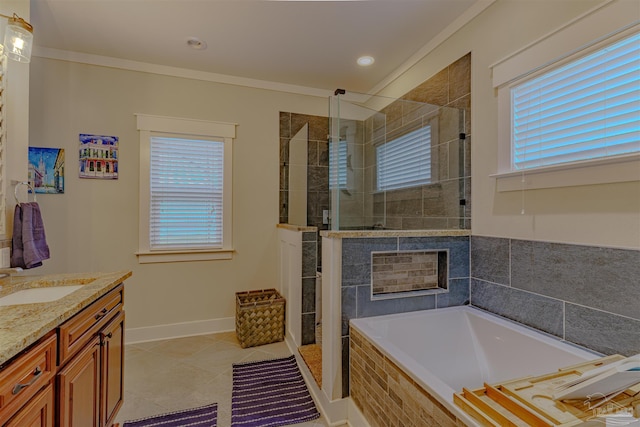 bathroom with a stall shower, tile patterned floors, vanity, a garden tub, and baseboards