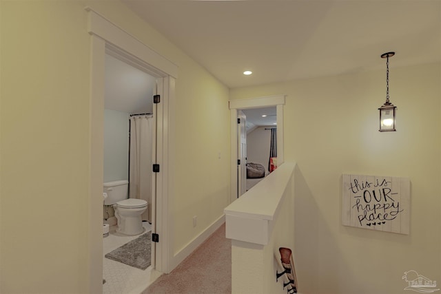 corridor with carpet floors, baseboards, and recessed lighting