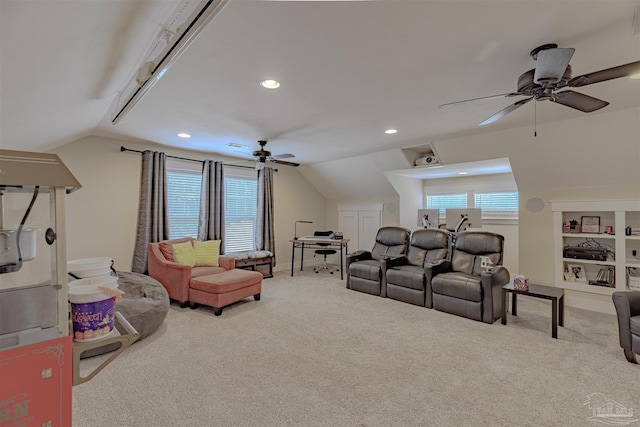 living area featuring a ceiling fan, carpet floors, lofted ceiling, and a wealth of natural light