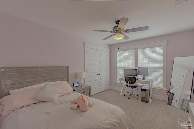 carpeted bedroom featuring baseboards, ceiling fan, and visible vents