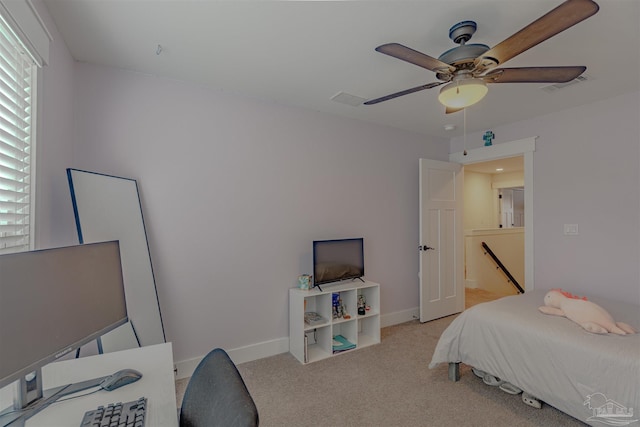 bedroom featuring light carpet, baseboards, visible vents, and ceiling fan