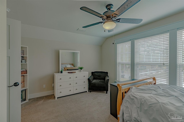 bedroom featuring vaulted ceiling, carpet floors, baseboards, visible vents, and ceiling fan