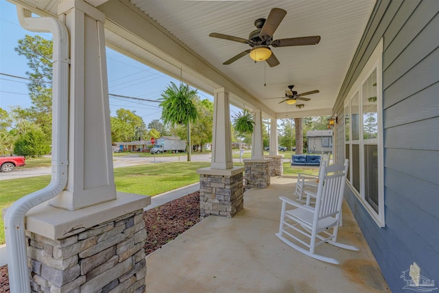 view of patio featuring ceiling fan and a porch