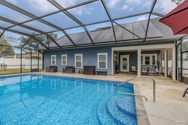 view of swimming pool featuring glass enclosure, a fenced in pool, fence, and a patio area