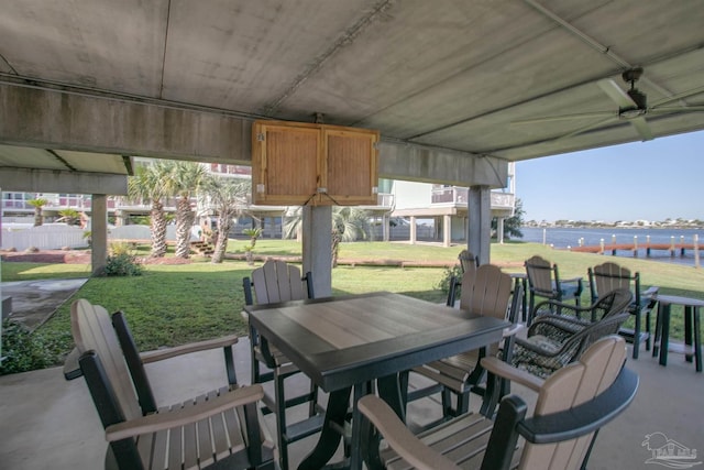 view of patio / terrace with a water view and outdoor dining space