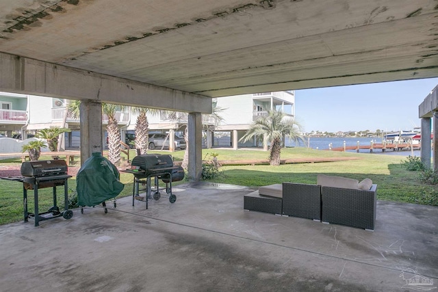 view of patio / terrace with a water view, an outdoor hangout area, and a grill