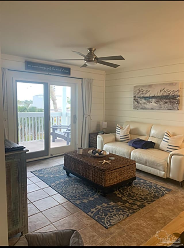16310 Perdido Key Dr Unit 13A, Pensacola, FL 32507 - tiled living area featuring a ceiling fan and wood walls