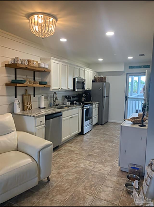16310 Perdido Key Dr Unit 13A, Pensacola, FL 32507 - kitchen featuring appliances with stainless steel finishes, a sink, white cabinetry, open shelves, and recessed lighting