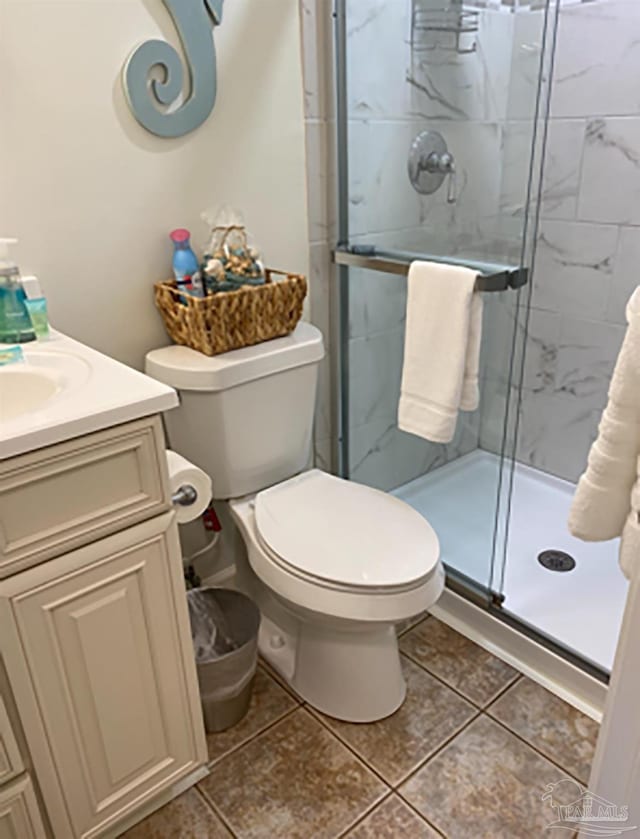 16310 Perdido Key Dr Unit 13A, Pensacola, FL 32507 - bathroom featuring a stall shower, tile patterned floors, toilet, and vanity