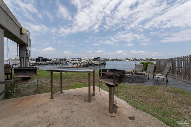 16310 Perdido Key Dr Unit 13A, Pensacola, FL 32507 - view of patio / terrace featuring an outdoor fire pit, a water view, and fence
