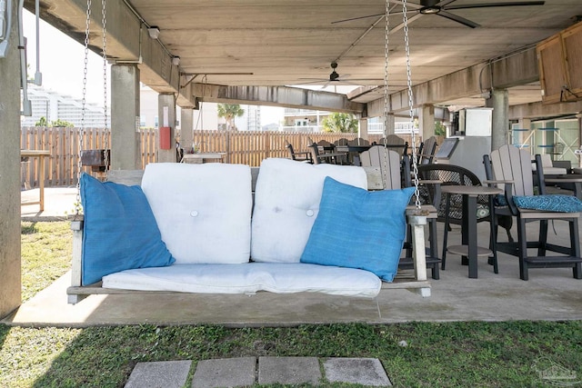 view of patio / terrace with fence, outdoor dining space, and ceiling fan