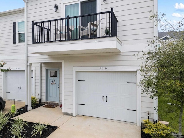 exterior space featuring a balcony and a garage