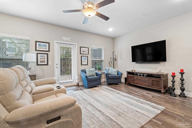 living room featuring ceiling fan and light wood-type flooring