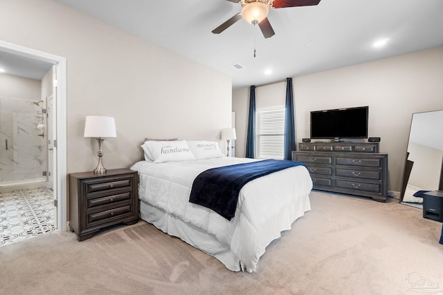 carpeted bedroom with ceiling fan and ensuite bath