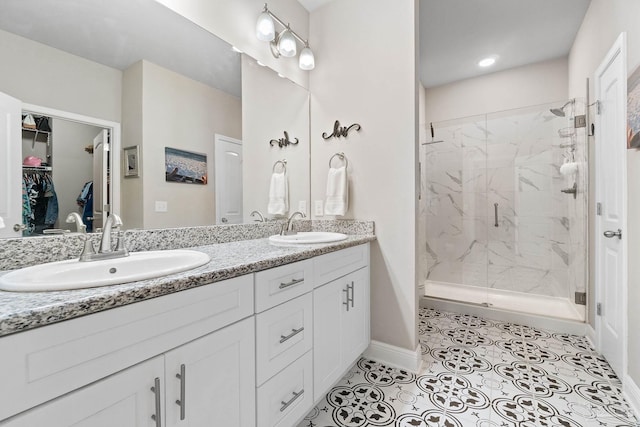 bathroom featuring vanity, a shower with shower door, and tile patterned flooring