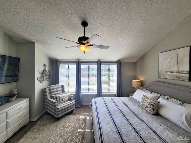 bedroom with lofted ceiling, ceiling fan, baseboards, and wood finished floors