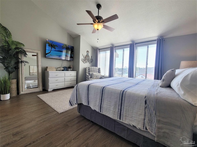 bedroom featuring lofted ceiling, ceiling fan, a textured ceiling, and dark wood-style flooring