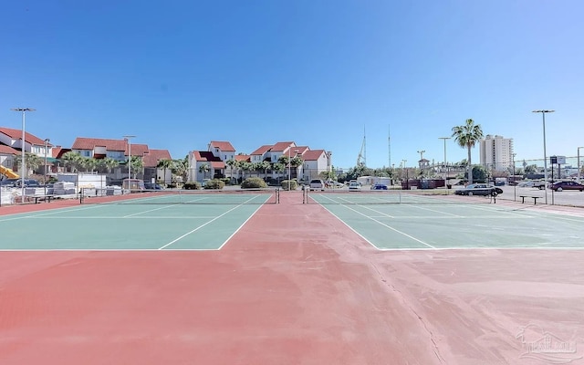 view of sport court featuring fence