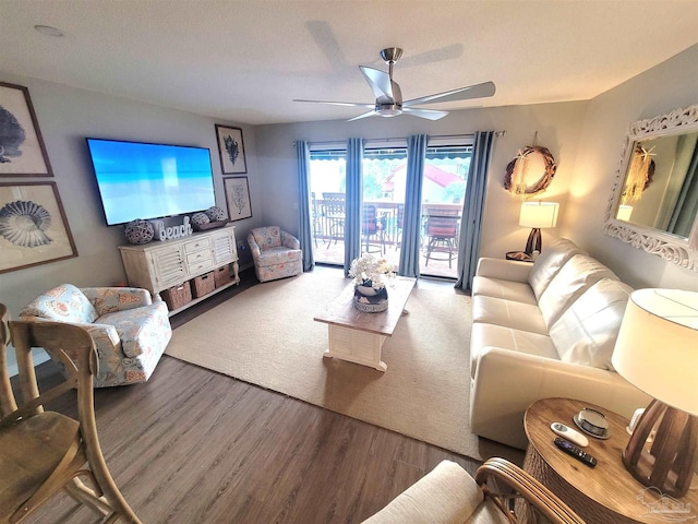 living room with a ceiling fan and wood finished floors