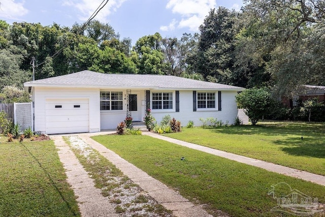 ranch-style home featuring a garage and a front lawn