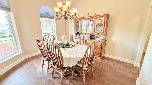 6214 Plum Orchard Way, Crestview, FL 32536 - dining room featuring a chandelier, light wood-type flooring, and baseboards