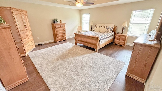 6214 Plum Orchard Way, Crestview, FL 32536 - bedroom with dark wood-type flooring, baseboards, and a ceiling fan
